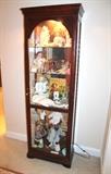 Howard Miller lighted curio cabinet and doll collection