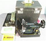 Antique Singer Featherweight Sewing Machine Singer Featherweight portable electric sewing machine No. 221-1 in hard black carrying case. Also includes Singer "Catalog 3-110" Sewing Motor, pedal, extra box of bobbins, "Singer Buttonhole Attachment No. 121795" with box and instructions, & more! Machine is in great condition, looks ready to use! Case edges are a bit rough. Serial No. AH195690. According to website, machine was made in 1947.