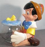 Walt Disney's Pinocchio Cookie Jar Darling Pinocchio cookie jar! Pinocchio, the loveable marionette puppet is holding his pet goldfish, Cleo in her fish bowl. Cookie jar is in two pieces made by Treasure Craft, measures 13.5" tall.