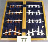 Ivory Chess Set in Hinged Wooden Case All ivory chess set with (natural) white and (Brown) dyed playing pieces. Original sticker reads "Ivory, Made in Hong Kong". Board is hinged and folds in half to latch closed. Pieces are kept inside, nestled in a blue velvet lining. Board measures 13" x 13" when fully opened.