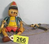 Vintage Wooden Pinocchio Puppet on Strings Vintage carved wooden Pinocchio marionette puppet on strings. Puppet has hinged arms and legs with hand chiseled detail. Measures: 14.5" tall.