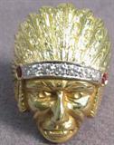 Jewelry 18kt Yellow Gold Indian Chief Ring Large, striking 18kt yellow gold ring shaped like a Native American Indian Chief wearing a headdress. Ring has 7 small round diamonds and 2 red stones, possibly rubies.
Size: 9.5, total weight: 13.0 dwt.
