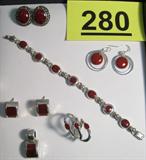 Jewelry Sterling Silver & Stone Bracelet, Ring + Beautiful sterling silver jewelry with red stones, possibly coral.
Link bracelet with inlaid red stones.
Matching earrings and pendant with inlaid stones, marked Mexico.
Oval shaped pierced earrings, round drop earrings.
Ring with wavy design and red stones, size 7.
Total weight: 2.530 ozt.