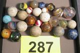 Mixed Lot of Antique Glass & Stone Marbles Great collection of 26 various sized children's toy marbles, some made of glass and others made of stone and other materials such as Mica. Swirled, Onion Skin, Ribbon and other colorful design patterns. Large majority of these marbles have surface chips and other signs of use, largest measures about 1 1/8" diameter x 3.75" circumference.