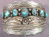 Jewelry Sterling Silver & Turquoise Cuff Bracelet Large and heavy Sterling Silver cuff bracelet with Southwestern style designs and 7 small rounded Turquoise stones across front, very nice detailing. No maker name or markings of any kind, measures 7".
Total Weight: 118.6 grams / 3.815 ozt
