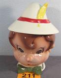 Vintage Pinocchio Cookie Jar AS-IS Vintage Pinocchio, figural, pottery cookie jar. "Hat" lid has been repaired, base has some crazing but overall in great condition. Cookie jar has "PoppyTrail Pottery, made in California" sticker and "Metlox Manufacturing Co." sticker attached.
Measures 10.75" tall.