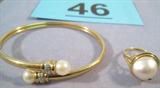 Jewelry 14k Yellow Gold & Pearl Bracelet & Ring Mixed Lot of 14k yellow gold items:
-- Wrap style bracelet with diamond & pearls. Bracelet measures 2 3/8" diameter.
-- Ring has large pearl set in 14k gold. Sized 7.25.
Total weight of lot is 7.6 dwt.