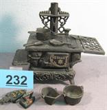 Antique Miniature Cast Iron Salesman Sample Stove Vintage miniature Cast Iron stove used as a salesman sample, made by Crescent in Taiwan. Appears to be complete and includes original parts, pots, pans, & utensils. Also comes with hand painted mini sad iron souvenir from Virginia City, Montana. Stove measures 8" height x 5" width x 9.25" length.