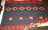 Vintage Native American Style Wool Rug / Blanket Large hand woven American Indian style wool blanket / area rug with red, dark brown, teal, and light brown coloration. Has usual signs of wear but no major damage, measures 68.25" width x 108.5" length.