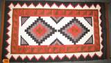 Vintage Handmade Native American Style Wool Rug Lovely hand woven American Indian style wool rug with various shades of red, beige, brown, grey and black coloration. Has some thread stitching along section of both side edges, look like it was done to keep rug from fraying. Some minor snags and signs of use, measures 58.5" length x 32.75" width.