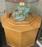 Turquoise Stone Art Sculpture 28" x 24" x 11.5" Beautiful authentic Turquoise stone art sculpture with elaborate carvings. Total weight of the Turquoise alone is 142 Pounds. Signed "A Western View" by Boy Apache and A. Rosell. The carvings are of an eagle, an Indian on horseback chasing a buffalo, bears, a train with an engine and three cars one with black coal, a pueblo village with Indian figures at various jobs, an owl, reindeer, a stage coach with driver and two horses, a bridge for the railroad tracks, another Indian with bow and arrow, cowboy on horseback, plus other superb carvings. The carvings are accented with rhinestone or glass gemstones, metal wire for reins, spears, a metal smoke stack on the train, horns on the reindeer, etc. The sculpture rest on a wooden "Lazy-Susan" with an octagonal glass top which is removable. A very rare piece and one of a kind.