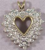 14kt Gold Heart Pendant w/ Diamonds Beautiful 14kt yellow and white gold heart pendant covered in small, round, brilliant cut Diamonds.
Pendant measures: 1" long, total weight: 3.6 dwt.