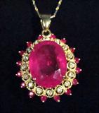 14kt Yellow Gold Ruby & Diamond Necklace
Elegant 14kt yellow gold necklace and pendant with Rubies and Diamonds.
Included GLA Premium Appraisal reads: 
"One lady's polished, stamped and electronically tested solid 14k yellow and white gold pendant mounted with: 1 genuine Ruby (Corundum), 16 genuine rubies (Croundum), and 16 genuine diamonds. This item weighs 15.10 grams and Measures: 40.66mm in length and 28.47mm in width, tapering to 5.12mm and includes a chain which measures 18.00 inches in length and 1.00mm in width. The chain has been finished with a lobster-claw closure. This pendant and chain combined weighs 15.10 grams. The condition is Brand New. The gemstones have been analyzed in the mounting. 
Main Gemstone: 
Identity: Genuine Ruby (Corundum)
Shape: Oval (faceted)
Dimensions: 20.00 x 15.53 x 7.99 mm (est)
Quantity: 1
Carat weight: (see below)
Clarity Grade: II=may include eye visible features
Hue: Fuscia pink
Transparency: Transparent
Tone: Light
Saturation: Vivid-Even
Polis