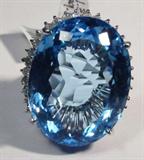 Jewelry 14kt White Gold Topaz & Diamond Ring
Stunning 14kt white gold ring with huge blue Topaz and several small diamond stones.
Included GLA Premium Appraisal reads: 
"One lady's polished, stamped and electronically tested solid 14k white gold ring mounted with: 1 genuine Blue Topaz and 36 genuine round full diamonds. This item weighs 28.60 grams and fits a finger size 7.50. The setting measures 9.53 x 16.73mm and the band measures 32.78 x 27.50mm and the band measures 4.03mm tapering down to 2.87mm at the center of the shank. The condition is Brand New. The gemstones have been analyzed in the mounting. 
Main Gemstones: 
Identity: Genuine Blue Topaz
Cut: Oval (checkerboard)
Dimensions: 29.71 x 22.9 x 13.51mm
Quantity: 1
Carat weight: 79.10 (est.)
Clarity Type: I= Variety flawless - near flawless
Hue: London Blue
Transparency: Transparent
Tone: Light
Saturation: Vivid-Bright
Polish: 8 Very good - Excellent
Finish: 9-Excellent
Quality: 10-Excellent - Fine
Adjacent Gemstones:
Identity: 