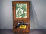 John Wayne Replica Six Shooter & Display Shelf
Any true John Wayne fan will want to add this display shelf and replica six shooter pistol to their collection. A natural wood frame holds a picture of the "Duke" and the gun rests on two bullet shaped hooks. Measures 22" x 11.5".