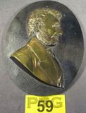 Vintage Brass Wall Plaque Image of Abraham Lincoln
A vintage brass wall plaque with the image of Abraham Lincoln molded into it. Measures approximately
10.5" x 8".