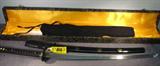 Replica Samurai Sword in Presentation Case
Replica Samurai Sword in presentation case with accessories. This is a beautiful sword with a decorative hilt and depiction of a Samurai warrior. The decorative case also contains a small celadon jar with a cork stopper and a ritual item wrapped in silk. The bright pristine unblemished 41" blade is razor shape steel and comes with the black scabbard and cloth sheath.