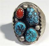 Jewelry Sterling Silver Turquoise Ring
Stately sterling silver Southwestern style ring featuring 3 turquoise nugget stones and polished red coral in sawthooth setting. Signed "NS", ring size: 11.5. Total weight: .87 ozt.