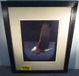 Art "Winged Majesty" Signed Print Kevin S Ballew
A gorgeous matted and framed print from an original painting by Kevin S. Ballew. Print is titled "Winged Majesty" and is pencil signed by the artist. An impressive American Bald Eagle is the subject of the print. Measures 22.25" x 18.25".
A brief artist's biography is attached to the back of the frame and reads in part, "Kevins S. Ballew strives to capture the soul of wildlife through the detail so important in bringing the animal to life on canvas. He starts most of his paintings on an acrylic black canvas. He then uses oil paint for the subject, often taking fifty or more hours for each painting."