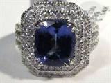 Jewelry 14kt White Gold Tanzanite & Diamond Ring
Fabulous 14kt white gold Tanzanite and Diamond ring. Size: 7.25.
Included AIG Pre-Sale Estimated Retail & Gemological report reads:
"One electronically tested 14kt white gold ladies cast Tanzanite and diamond ring. The featured Tanzanite is set within a tiered diamond bezel, supported by diamond set shoulders and completed by a two and on half millimeter wide band. Bright polish finish with a milgrain detail. Identified with markings of "14k". Containing:
One prong set rectangular cushion mixed cut natural Tanzanite, measuring 10.00 x 8.80 x 5.50mm, approximate weight of 4.09ct., clarity is eye clean, type 1, medium dark, very slightly grayish, bluish violet color, (GIA bV 6/3) to medium dark, very slightly grayish, bluish purple, (GIA bP 6/3), cut is good. Transmitting light with no destortion, transparent. The stone displays 40% extinction. Graded in the setting. 
Tanzanite is a very rare gemstone that is only found in the country of T