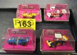 Lot of 4 Vintage Aurora G-Plus Toy Slot Cars w Box
Lot includes the following vintage HO Scale toy race cars made by Aurora Products Corporation:
 - Car #1 is the Indy Special, appears to be in its original box. Aurora AFX Model Motoring Racing Guide is affixed to the bottom of the box.
 - Car #4 is the blue and yellow "elf" Goodyear car. Appears to be in its original box.
 - Car #7 is the red and yellow "lola" Goodyear car. Appears to be in its original box.
 - Car #11 is the red and white Texaco & Marlboro car. Appears to be in its original box.