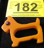 Vintage Bakelite Napkin Ring Scottie Dog Amber Eye
A vintage bakelite napkin ring shaped like a little Scottie dog. Caramel color with amber eyes. Measures approximately 2" x 2.75".