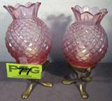 Fenton Diamond Point Glass Candle Holders
A beautiful pair of Fenton Diamond Point pink glass and brass candle holders. The pink glass globes are pineapple shaped and sit atop a three legged brass candle holder. The Fenton Art Glass Company was closed in October 2011. If you don't own any Fenton glass take advantage of this lot to own your own piece of history. Each measures 10" tall with a 5" diameter. No chips or cracks.