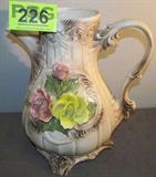 Large Capodimonte Flowered Vase Italy
A fabulous large Capodimonte flowered vase made in Italy. The vase is adorned with a pink and yellow bloomed rose along with a pink rose bud. Some crazing exists on this piece and there are a couple of very small chips in the rose petals but it does not inhibit the breath taking beauty of this piece. Measures an incredible 15.5" tall with a 12" diameter.