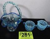 Mixed Lot Fenton Blue Basket & Hob Nail Glass
This beautiful lot includes:
- A pretty Fenton Art Glass blue ruffled rim basket. Measures 7.25" tall. Signed Fenton.
- A set of two small blue hob nail glass pitcher and sugar bowl. Each piece measures 2" tall. Pieces are not marked.
There are no chips or breaks on these items.