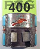 Jewelry Large Sterling & Multi Stone Cuff Bracelet
Beautiful & sizable sterling silver inlaid cuff bracelet featuring pale blue and yellow rectangular stones alternating across 2 rows, turquoise & coral detailing, southwestern style. Coral arranged into the shape of a bird in the center of the bracelet, with detailed leaf design. Beneath this picture are two sprays of a sterling silver design protruding from the bracelet. Marked / signed "H. Spencer". Measures 2.75" across (est) and 2.5" tall (est).
Total weight: 5.12 ozt