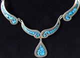 Jewelry Sterling Silver & Turquoise Necklace
Gorgeous southwestern style sterling silver choker style necklace featuring several panels with flecks of turquoise against a dark blue background, cast in swirled designs and accented with sterling silver frames, with a tear drop pendant of the same design at the center of the necklace. Necklace terminates with a box tab insert clasp, measuring 15.25" long (est). Marked / signed "Mexico 925".
Total weight: 1.06 ozt