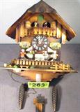 Vintage Swiss Chalet Style Musical Cuckoo Clock
Vintage Swiss Chalet style musical cuckoo clock is identified with only a paper label on the back from the Alpine Clock Shop, Phoenix, AZ. Beautifully decorated with wooden Bavarian style musician figures in the front and Polka dancing couples just under the Cuckoo's door. Clock has a wooden pendulum and two weights. Working condition is unknown. Measures approx: 12" in width, 7.5" in depth, and 14" tall without the pendulum or weights attached. A small decorative green vegetation piece is missing from the front platform.