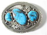 Jewelry Large Sterling Silver & Turquoise Buckle
Large Southwestern style sterling silver belt buckle accented with 3 large turquoise stones in sawtooth setting. Buckle has beautiful metal work of flowers and feathers. Signed "BCM", measures: 3.25" wide x 2.5" tall. Total weight: 2.30 ozt.
