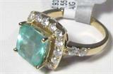 Jewelry 14KT Yellow Gold Emerald & Diamond Ring
A dazzling 14KT yellow gold, emerald & diamond ladies ring fitting a finger size 7.25. Included AIG Gem & Jewelry Report reads:
"One electronically tested 14KT yellow gold ladies cast emerald and diamond ring with a bright polish finish. Condition is new, good workmanship. The featured emerald is set within a diamond lattice gallery, supported by diamond set shoulders & completed by a two millimeter wide band. Trademark is RT. Identified with markings of '14K'. Containing:
One prong set square step cut natural emerald, measuring 9.40 x 9.00 x 6.85mm, approximate weight of 3.55ct., clarity is heavily included, type III, medium, slightly grayish, very slightly bluish green color, (GIA vslbG 5/2), cut is good. Transmitting light with a minimum of distortion, transparent. Naturally occurring internal & external characteristics are present. Indications of oil & opticon residue. Graded in setting.
Twenty prong set round brilliant cut diamonds,