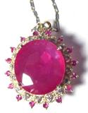 Lot#: 73a
Description: Jewelry 14KT Yellow Gold Ruby & Diamond Necklace
Stunning 14KT yellow gold, ruby & diamond necklace. Included AIG (American International Gemologists) Pre-Sale Report reads: "One electronically tested 14KT yellow gold ladies cast & assembled ruby & diamond pendant with chain with a bright finish. The pendant features an oval shape ruby set within an inner diamond bezel and an outer ruby bezel. The pendant is supported by a 14KT white & yellow gold seventeen inch length one millimeter wide designer style chain. Condition is new, good workmanship. Containing:
One prong set oval mixed cut natural ruby, measuring 19.60 x 18.00 x 6.02mm, 27% bulge factor, approximate weight of 23.09ct., clarity is heavily included, type II, medium dark, very slightly brownish, slightly purplish red color, *CIA slpR 6/3), cut is good. Transmitting light somewhat diffusely, translucent. Naturally occurring internal & external characteristics are present. Indications of laboratory hi
