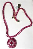Jewelry 14KT Gold Ruby & Diamond Necklace
Astonishingly beautiful 14KT gold ruby & diamond necklace. Included AIG Gem & Jewelry Report reads:
"One electronically tested 14KT yellow gold ladies cast & assembled ruby & diamond necklace. The necklace features a tiered ruby and diamond set floret pendant, supported by a ribbon of rubies, seventeen inch wearable length, terminating in a box clasp with safety. Identified with markings of '14K'. Condition is new, good workmanship. Containing:
One prong set oval cut natural ruby, approximate weight of 3.02ct., clarity is heavily included, type II, medium dark, very slightly brownish, red color (GIA R 6/3), cut is good. Transmitting light somewhat diffusely, translucent. Naturally occurring internal & external characteristics are present. Indications of laboratory high temperature heat treatment, with glass & flux additives. Graded in setting. Ruby has a low tolerance to rhodium plating, repolishing the surface, & ultrasonic cleaning.
One hund