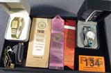 Mixed Lot Wenger Watch / Cub Scout Tie Clip & More
A great mixed lot which includes:
- Swiss Wenger wrist watch. Twist flex band with turquoise and onyx like settings. Appears to be in the original box.
- Gold color Pulsar wrist watch with a metal chain link band.
- Gold color Cub Scouts tie clip.
- Small Opinel single blade knife in a key chain clip on holder.
- Purple ribbon, 1958 first place ribbon from the Jackson, MS state fair, Rabbit Breeders Association.
- Red ribbon, 1959 second place ribbon from the Mississippi Academy of Science Fair.
- White ribbon, 1957 third place ribbon science award.