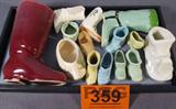 Lot of 13 Glass Shoe & Boot Figurines
A marvelous lot of figural glass / ceramic boot and shoe figurines in a variety of styles and colors:
- Cowgirl style boot figurine with flower designs that appear hand painted. Not marked nor dated. 3" tall.
- Dutch style shoe figurine with decal flower design. Has some crazing. Not marked nor dated. 1.5" tall.
- Reddish brown boot figurine. Marked U.S.A. 7" tall.
- Baby's first walking shoe figurine. Not marked nor dated. 2.5" tall.
- Ladies wedge style high heel figurine. 2" tall.
- Elf style shoe figurine 1.25" tall.
- Western boot style figurine with flower design that appears to be hand painted. 4.5" tall.
- More.