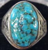 Jewelry Sterling Silver Turquoise Men's Ring
Fabulous sterling silver ring with Southwestern style eagle designs, featuring large nugget style turquoise stone. Unmarked, appears to be sterling, ring size: 12. Total weight: .40 ozt.