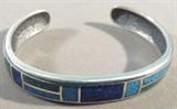 Jewelry Sterling Silver Lapis & Turquoise Bracelet
Beautiful sterling silver cuff bracelet featuring inlaid Lapis Lazuli and turquoise stones in mosaic style design. Marked "CCO 925", measures: 5.5" wide with 1" opening. Total weight: .97 ozt.