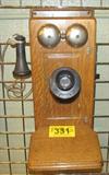 Vintage Western Electric Company Wooden Wall Phone
This vintage hand crank wall phone appears to be made of oak. Metal mouthpiece is marked "Western Electric Company". Cord on earpiece is labeled "Runzel 2R14". There are a few cracks in the wood and the item shows signs of wear from age and use. Measures 23" tall x 9.25" across and 15" in depth.
