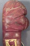 Rocky Marciano Muhammad Ali Autographed Glove ACE
A left hand Everlast leather boxing glove autographed by Muhammad Ali and Rocky Marciano. Signatures are certified by Autograph Certification Experts, LLC, Justin Chris Priddy, President. Certification # B39916 can be verified at www.autographcertificationexperts.com.
From the internet: ". In the late 1960’s, a Miami boxing promoter, who had a successful radio series of fantasy boxing bouts between champs of years past, fed their statistics into a computer, which predicted a "winner." Based on the popularity of these fights, he convinced a retired Rocky Marciano and a suspended Muhammad Ali to meet in the ring for filmed fight based on the computer results. On January 20, 1970, The "Fight of the Century – Ali vs. Marciano" was show one time in 1500 theatres across the United States and EuropeI aired on January 20, 1970, with Marciano winning by knockout in round 13 in North American theaters and Ali winning in European theaters. Also sh