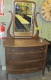 Furniture 3-Drawer Oak Dress w/ Swivel Mirror
A vintage 3 drawer oak dresser with swivel mirror. Drawers appear to have their original wooden knobs and are constructed with dove tail joints. Each drawer has a skeleton key locking mechanism. Skeleton key is not provided. Caster wheels on all four legs. Shows signs of wear from age and use and has a large crack in the decorative wood that holds the mirror frame. Measures 68" tall x 38" across x 21" in depth.