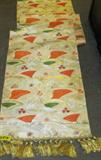Vintage Japanese Silk Tapestry Wall Hanging
An amazing silk tapestry with floral and fan shaped designs. Elegant orange, red and green designs are bordered and interwoven with gold accents. One end of the tapestry has lovely gold tassels. A label indicates that the item was made in Japan. Measures 26.5" wide and an incredible 13'8" long.