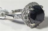 Jewelry 14kt White Gold Black & White Diamond Ring
Gorgeous 14kt white gold ring featuring black and white diamond stones, ring size: 7.25. Included AIG Pre-Sale Estimated Retail & Gemological Report Reads: "One electronically tested 14kt white gold ladies cast black and white diamond ring with a bright polish finish. condition is new, good workmanship. The featured black diamond is set within a white diamond lattice gallery supported by diamond set shoulders and completed by a two millimeter wide band. Trademark is Orianne. Identified with markings of "14k". Containing:
One prong set round briliant cut diamond, measuring 10.60 - 10.60 x 8.00mm (depth est.), 11.00% GTCF approximate weight of 6.11ct. Indications of multiple laboratory enhancements. Graded in the setting.
Clarity: Declasse
Color: Fancy Black; Irradiated
Depth: 75.5%
Table: 64.2%
Twenty-eight prong set round brilliant cut diamonds, measuring 2.50 - 1.60 x 1.23mm (depth est.) approximate total weight of 28 stones = 0.63c