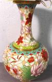 Oriental Style Cloisonne Vase
A beautiful brass color metal vase appears to have a painted enamel Cloisonne finish. The flower design features red, blue, green and purple colors. Measures 8" tall with a 5" diameter.