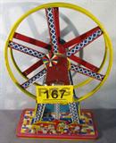 Ohio Art "The Giant Ride" Wind Up Ferris Wheel
A fantastic vintage tin / metal toy Ferris wheel made by the Ohio Art Company. The most visible ride at the carnival has always been the towering Ferris wheel, aptly this toy is called "The Giant Ride". Pictured at the base of the wheel is the midway entrance with popcorn, hot dog and soft drink stands. Plastic bucket cars are missing from the piece and the wind up mechanism does not work properly. Item does have some rust spots from age and use. Measures 16.25" tall. Base is approximately 11" x 5".