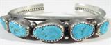 Jewelry Sterling Silver Turquoise Cuff Bracelet
Fabulous sterling silver cuff bracelet featuring 5 turquoise stones in sawtooth setting. Marked / signed "R. Bennett sterling", measures: 5.25" wide with 1" opening. Total weight: .80 ozt