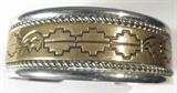 Jewelry Sterling Silver & Gold Filled Bracelet
Stately sterling silver cuff bracelet with gold filled accent. Bracelet has Southwestern style bear designs. Signed / marked "T Sterling 1/20 12k GF". Measures: 5.5" wide with .75" opening. Total weight: .97 ozt.