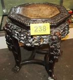 Furniture Chinese Style Teak Marble Top Table
Lovely Chinese style teak carved table / stand with octagon shaped top inset with marble. The table has ornately detailed floral carvings on all four sides and ends in paw feet. A paper label on the bottom identifies the piece as "Made in China". The underside of the marble top is stamped with a red ink manufacturer's mark. Table measures approximately 19" tall with a 17" diameter.
